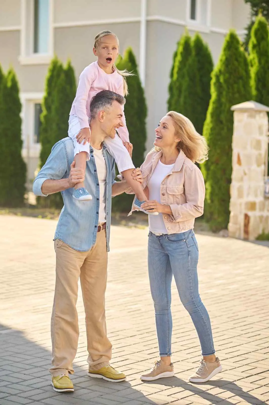 Family standing together outside their home